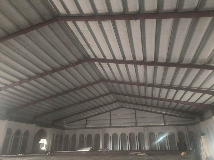 Engineered steel truss roof structure over arched hall walls, architectural design by Al Azeem Engineering Islamabad