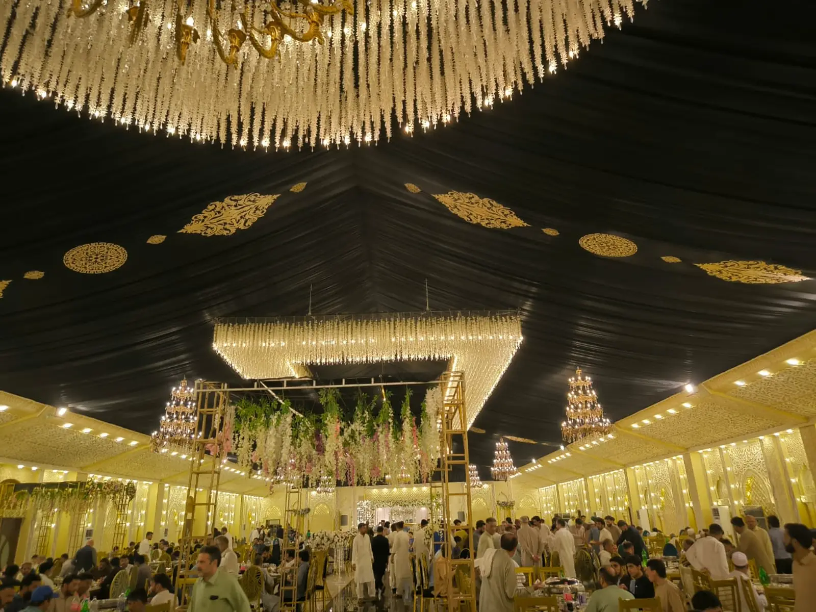 Finished banquet hall interior with chandeliers and floral ceiling installation, design and build company Islamabad